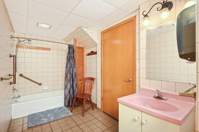 bathroom featuring tile patterned floors, shower / bath combo, a paneled ceiling, and vanity