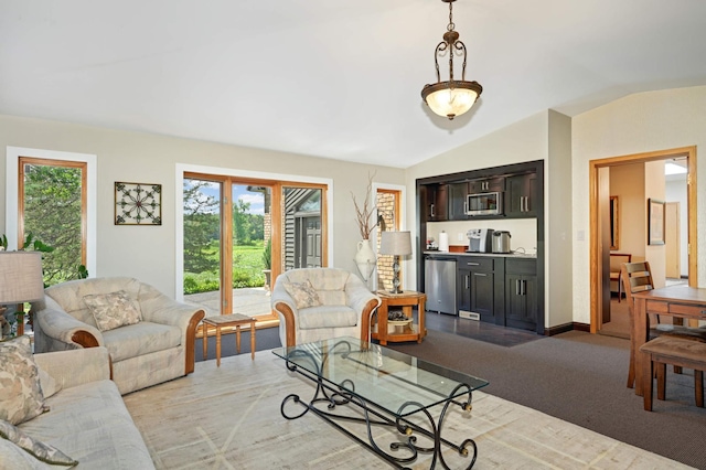 living room featuring vaulted ceiling and light hardwood / wood-style floors