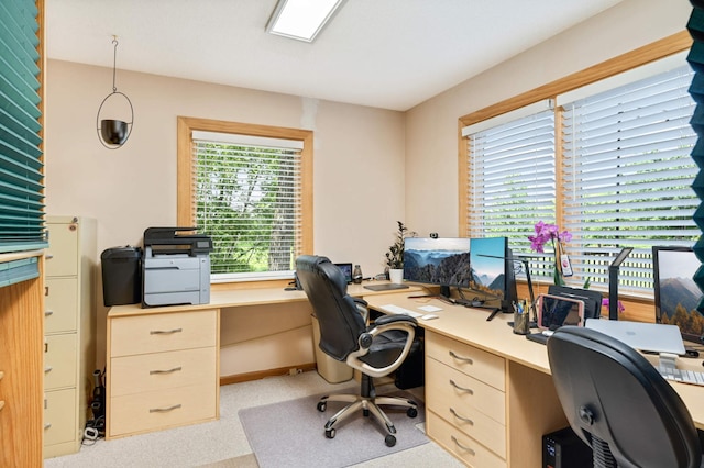 carpeted home office featuring built in desk