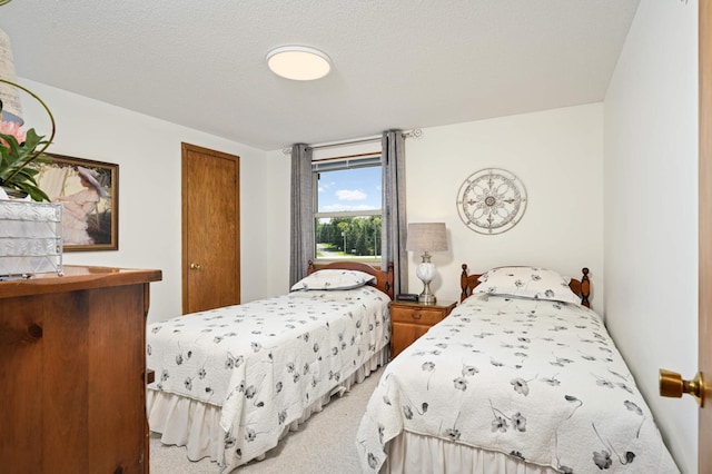 carpeted bedroom with a textured ceiling