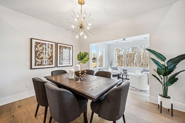 dining area featuring light hardwood / wood-style flooring and an inviting chandelier