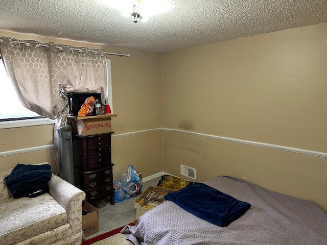 carpeted bedroom with a textured ceiling