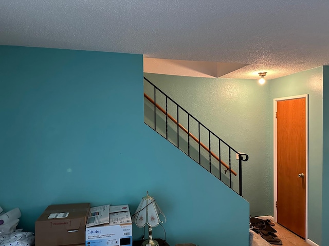 entryway featuring a textured ceiling and tile patterned flooring