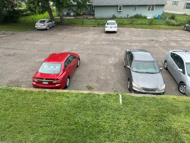 view of vehicle parking with a yard