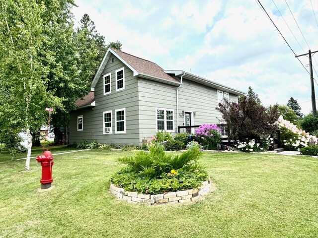 rear view of house featuring a yard