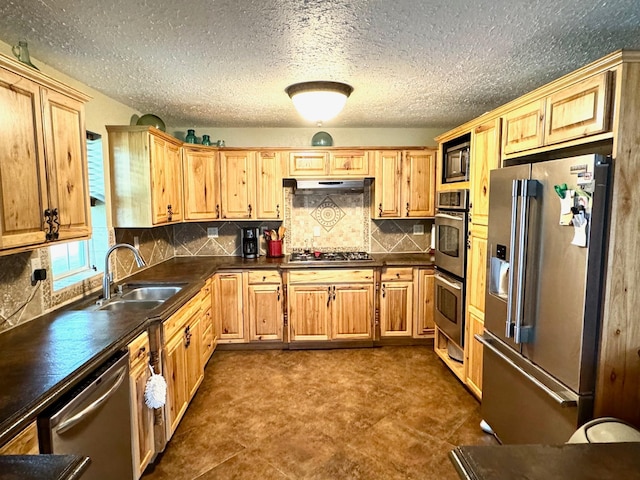 kitchen featuring sink, stainless steel appliances, dark tile patterned floors, and tasteful backsplash