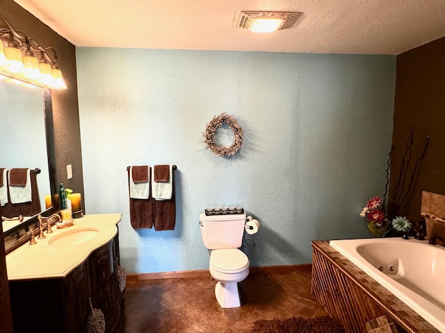 bathroom with toilet, tile patterned flooring, vanity, a washtub, and a textured ceiling