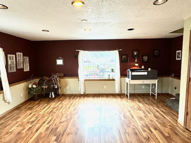 interior space featuring hardwood / wood-style flooring and a textured ceiling