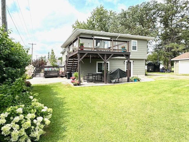 rear view of house with a wooden deck, a patio area, and a yard