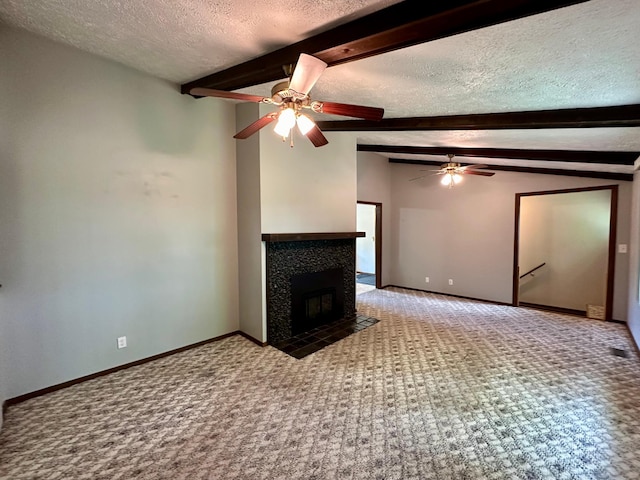 unfurnished living room featuring a textured ceiling, a fireplace, light carpet, and beamed ceiling