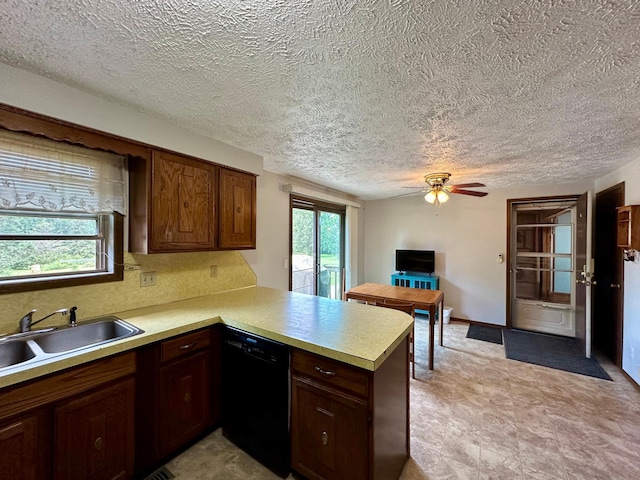 kitchen with kitchen peninsula, black dishwasher, a textured ceiling, ceiling fan, and sink