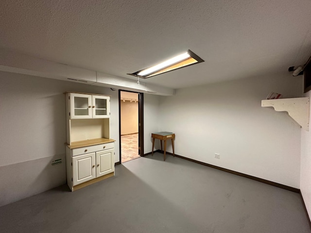 basement featuring a textured ceiling