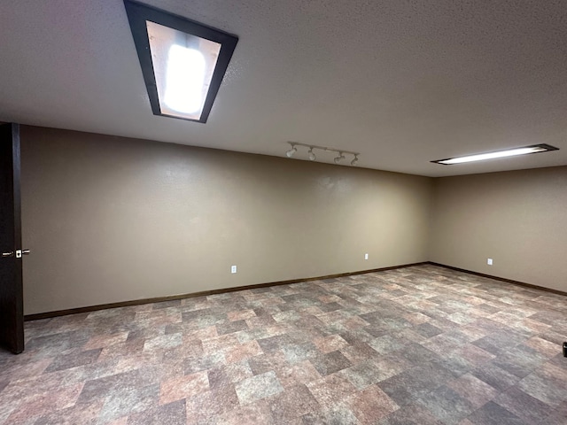 additional living space with a textured ceiling