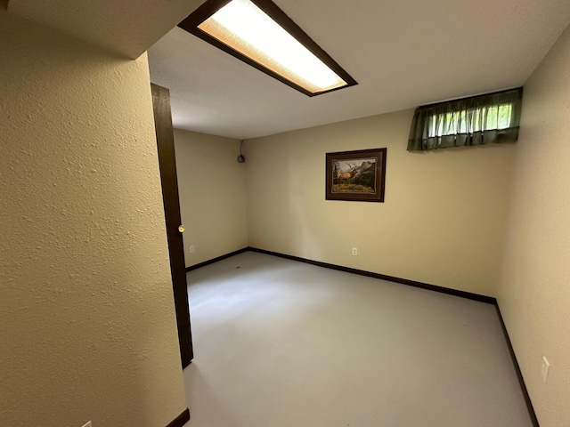 unfurnished room with concrete flooring