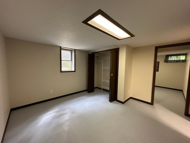 basement featuring a textured ceiling