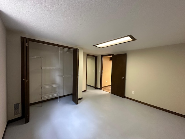 unfurnished bedroom featuring a closet and a textured ceiling