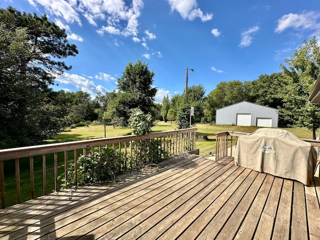 wooden deck with an outdoor structure, a garage, and a lawn