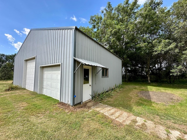 garage featuring a lawn