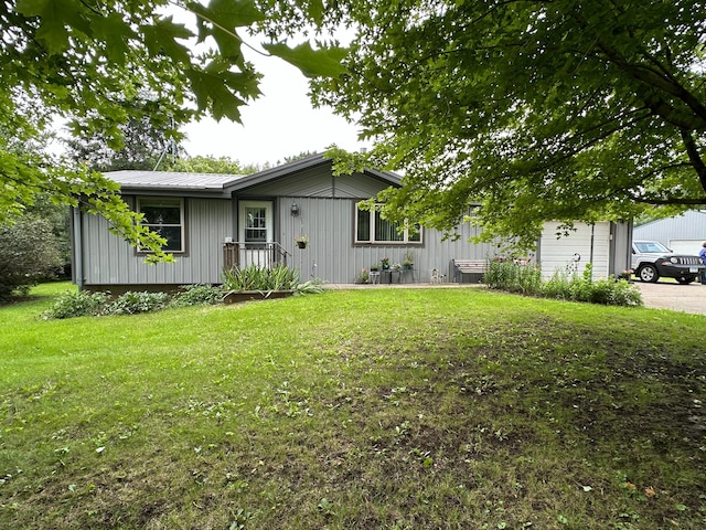 single story home with a front yard and a garage