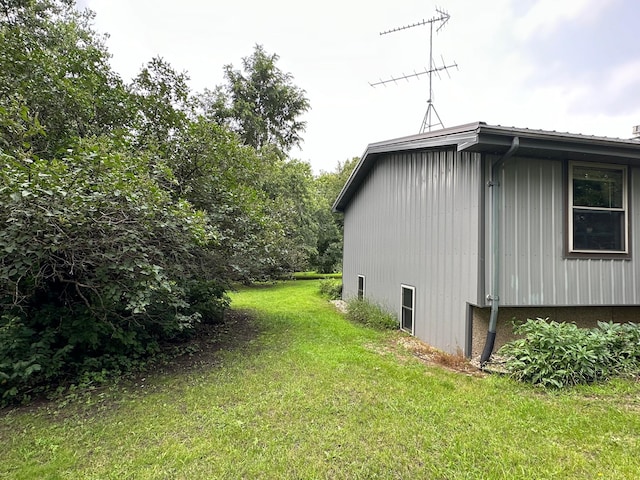 view of side of home featuring a lawn