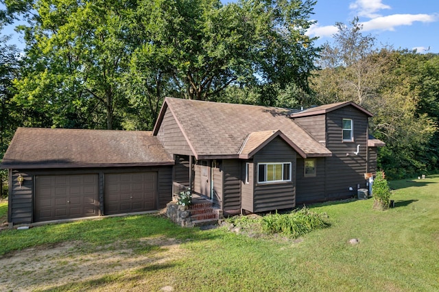 view of front of house with a front yard and a garage