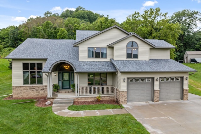 view of front of house with covered porch, concrete driveway, a front yard, roof with shingles, and brick siding