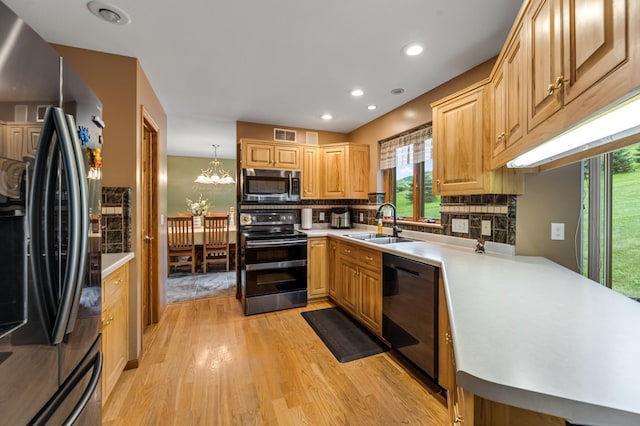 kitchen with stainless steel microwave, dishwasher, range with two ovens, freestanding refrigerator, and a sink