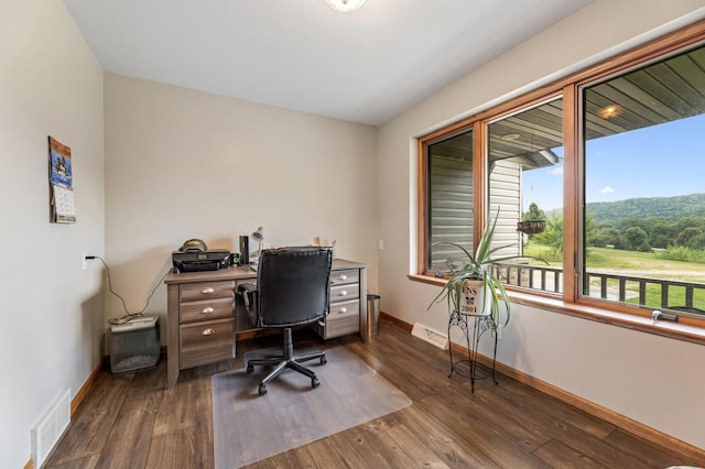 home office with visible vents, baseboards, and dark wood-style flooring