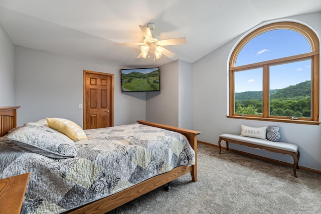 carpeted bedroom featuring ceiling fan, baseboards, and vaulted ceiling