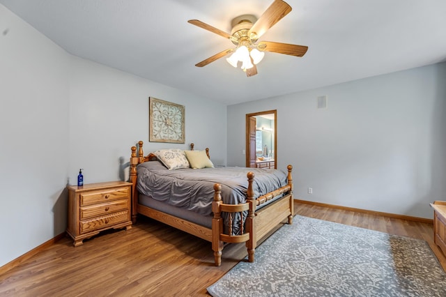 bedroom featuring baseboards, light wood-type flooring, and ceiling fan