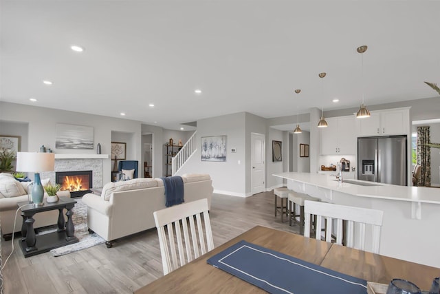 dining space with sink and light hardwood / wood-style flooring