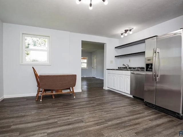 kitchen featuring stainless steel appliances, sink, plenty of natural light, and dark hardwood / wood-style flooring