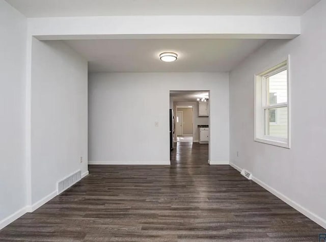 spare room featuring dark hardwood / wood-style flooring