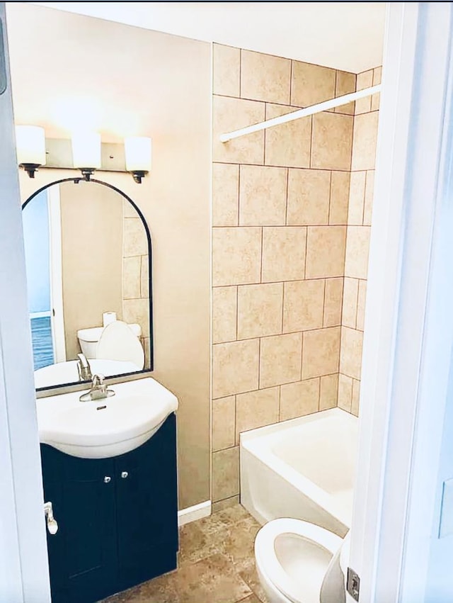 full bathroom with tiled shower / bath combo, vanity, and toilet