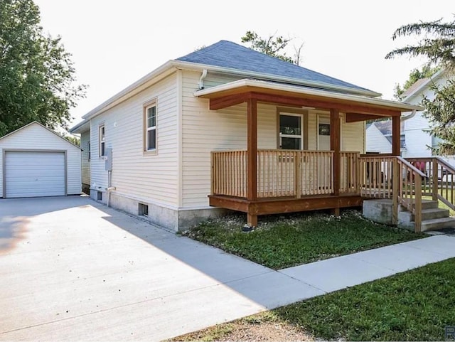 view of front of home featuring a garage, an outdoor structure, and a porch