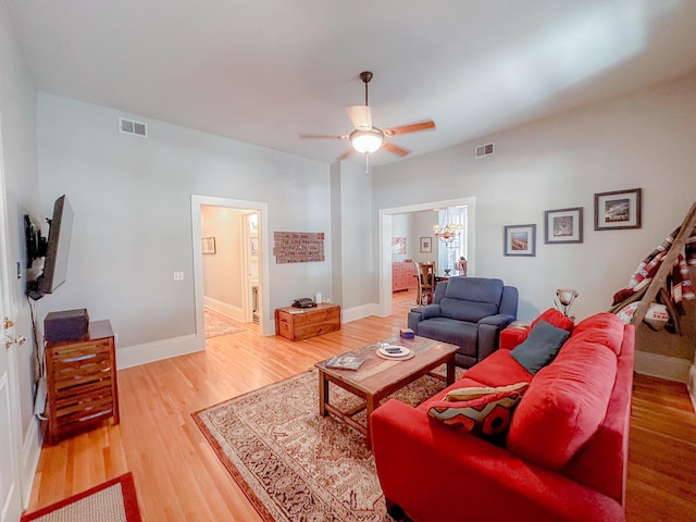 living room with hardwood / wood-style flooring and ceiling fan