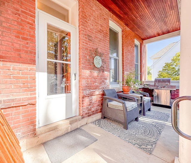 view of patio with a grill and a porch