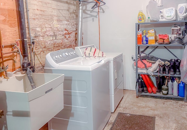 laundry room featuring independent washer and dryer and sink