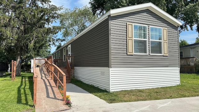 view of home's exterior featuring a lawn and a deck