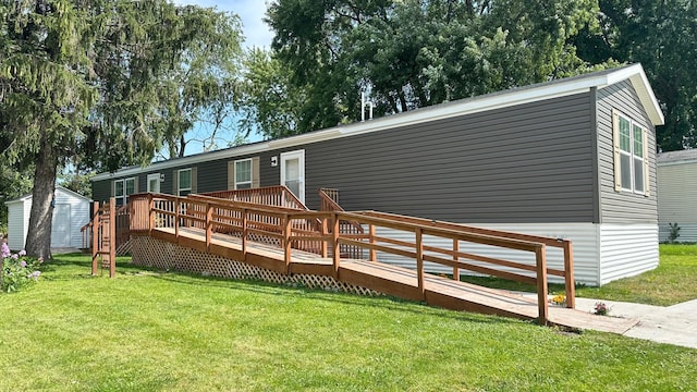 view of front of home with a deck and a front lawn