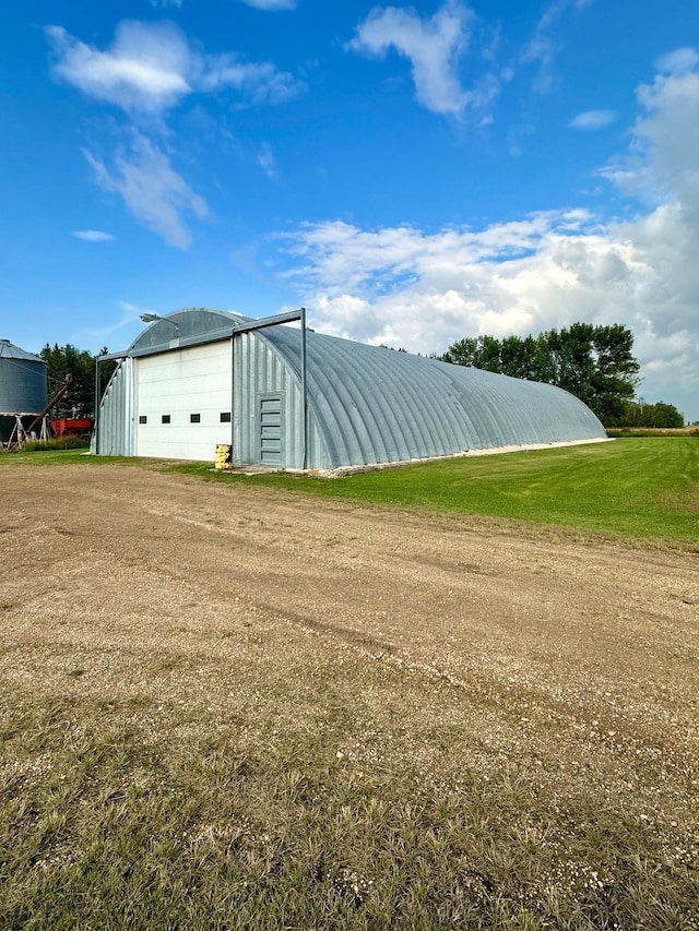 view of outbuilding with a yard