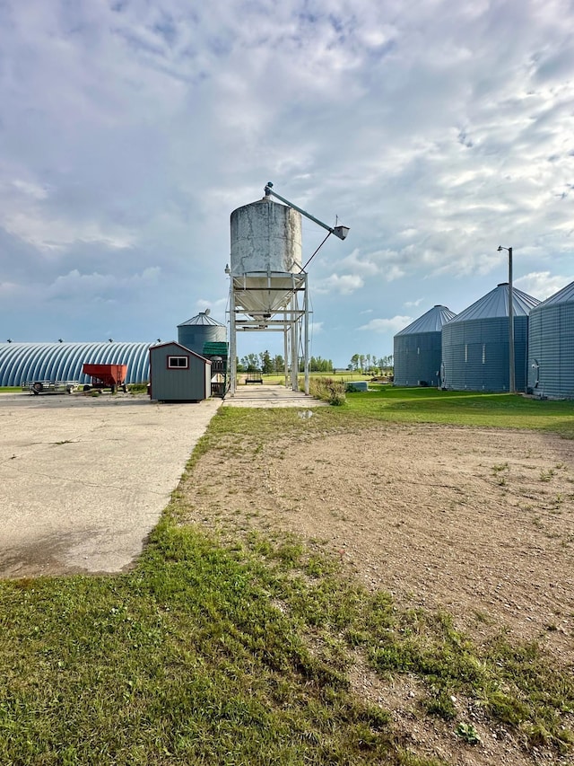 surrounding community featuring a storage shed and a yard