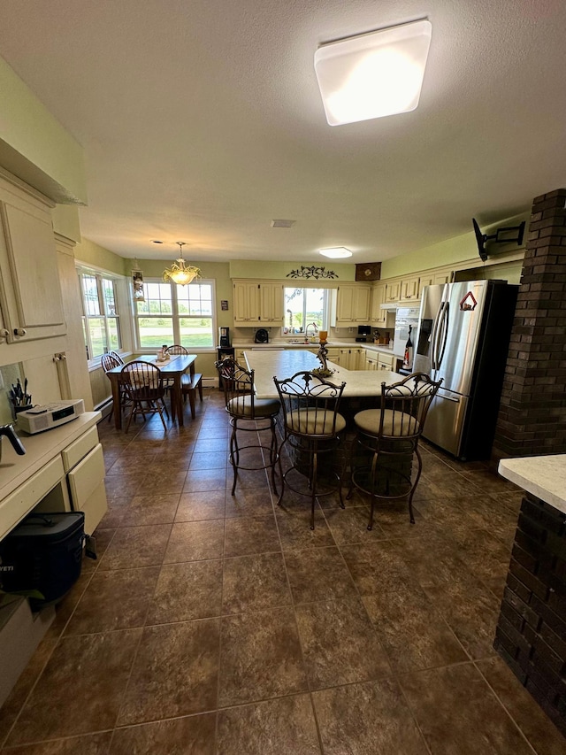 tiled dining room featuring brick wall