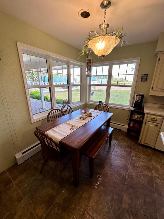 dining room with dark tile patterned floors and a baseboard radiator