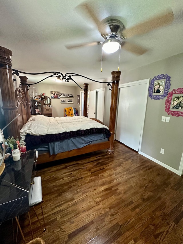 bedroom with ceiling fan, wood-type flooring, and a textured ceiling