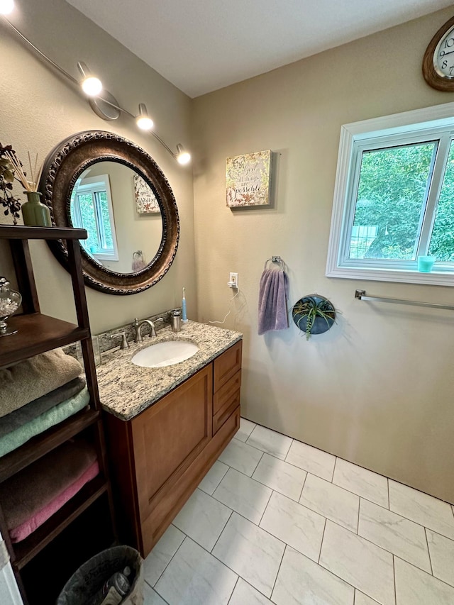 bathroom with a healthy amount of sunlight, vanity, and tile patterned floors