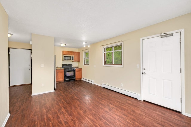 unfurnished living room featuring dark hardwood / wood-style floors, a textured ceiling, and a baseboard heating unit