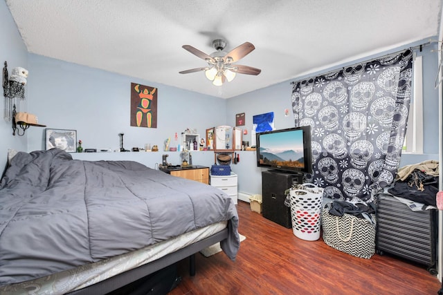 bedroom featuring a textured ceiling, wood-type flooring, and ceiling fan