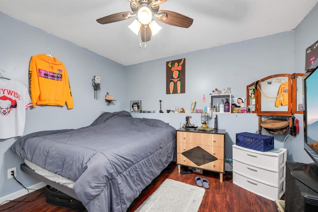 bedroom with dark hardwood / wood-style floors and ceiling fan