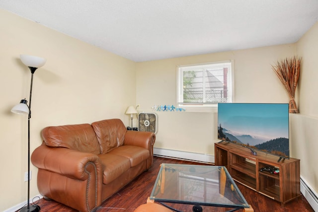 living room with a baseboard heating unit and dark hardwood / wood-style floors